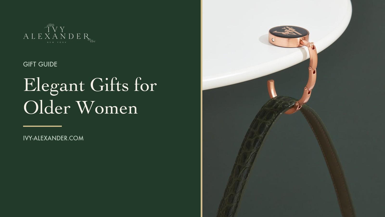 The Ivy Alexander Madison hook with its dark green enamel disc hanging a strap from the edge of a white table, beside the title Elegant Gifts for Older Women.